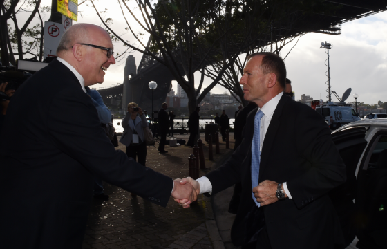 Senator George Brandis, left, has labelled some critics of former Australian PM Tony Abbott, right, as hypocritics