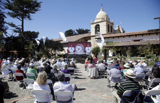 Worshippers watch the canonisation of St Junipero Serra by Pope Francis in Washington on a big screen at the Carmel Mission