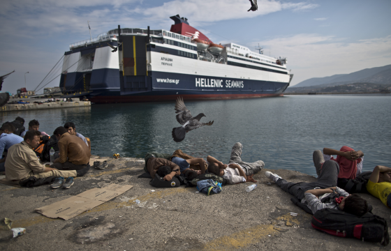 Afghans who have made the long trip to the Greek islands sleep on a dock on Lesbos