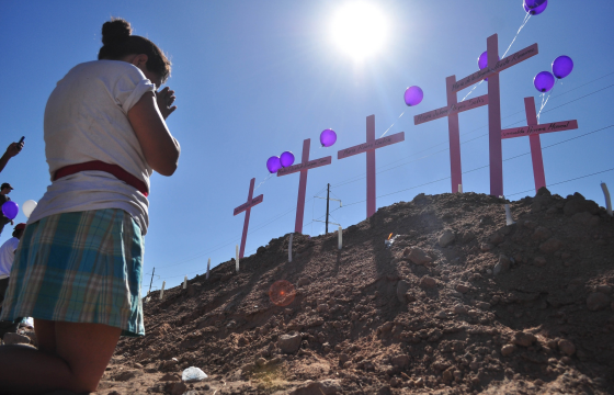 A woman prays at a memorial for eight women found murdered in the border town of Ciudad Juarez