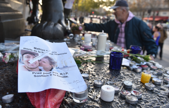 A picture of two victims of the Paris terror attacks surrounded by candles at a memorial on Sunday