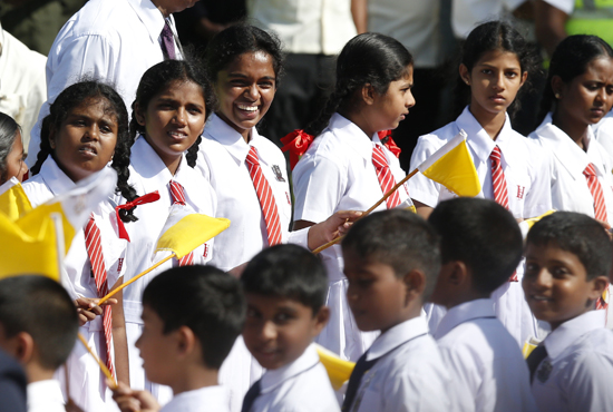 schoolgirls await Pope Francis' arrival in Colombo