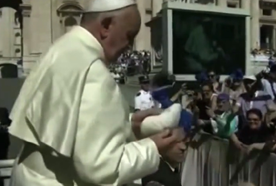 Pope Francis handed a skull cap by tv presenter