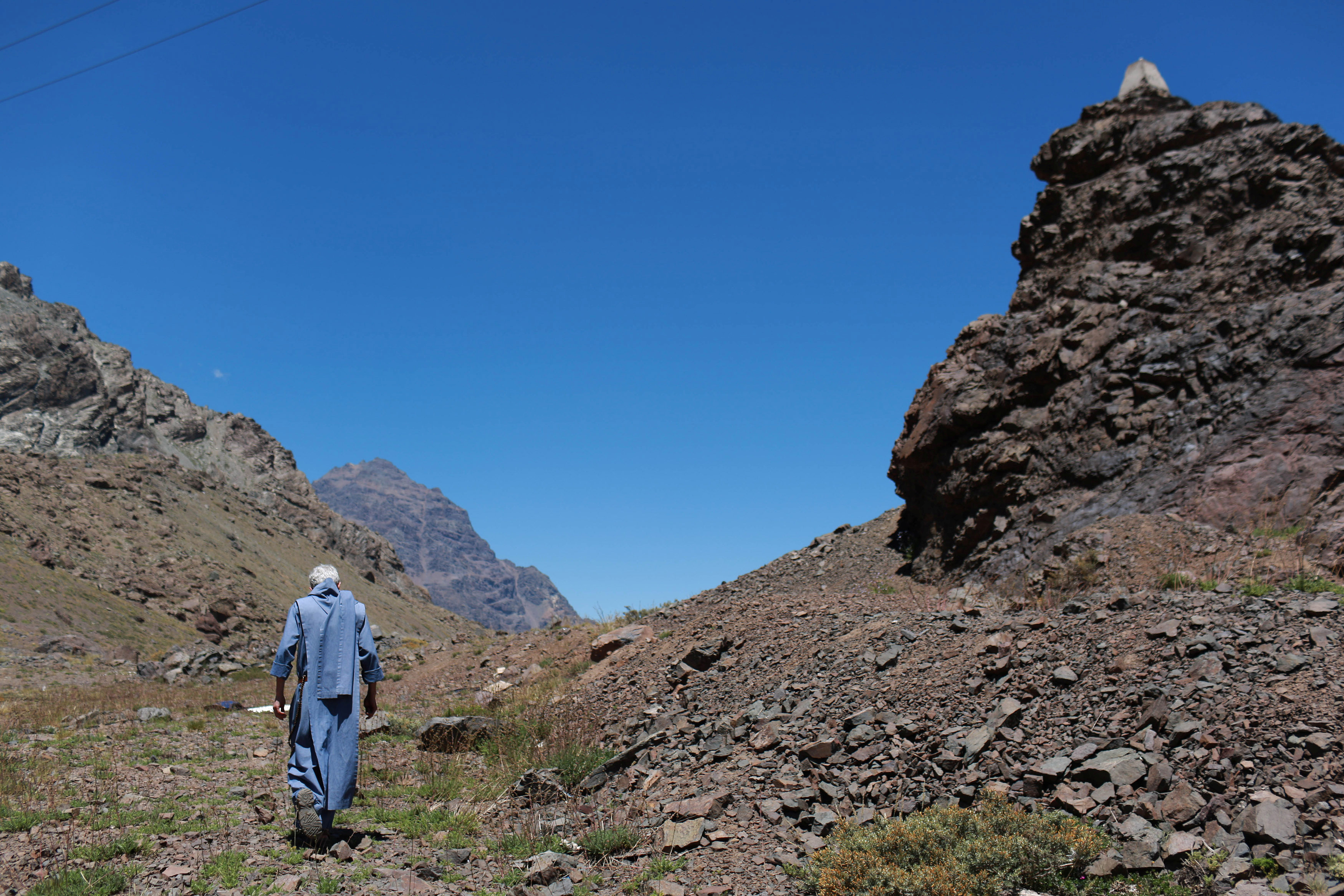 Priest walks in mountains in Chile