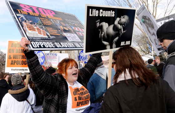 Pro-life and pro-choice campaigners clash outside the Supreme Court building in Washington