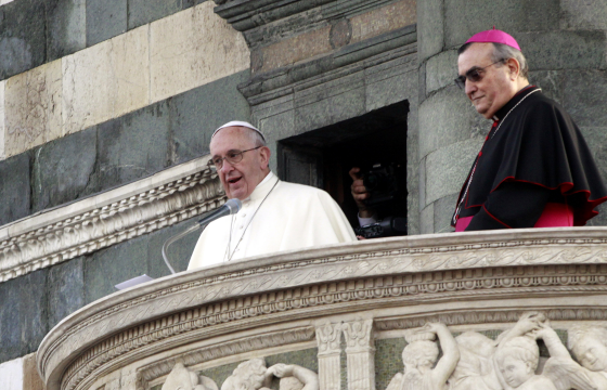 Pope Francis speaks from the cathedral balcony in Florence to young people and foreign workers