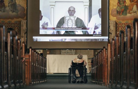 Millie Volpetti, 77, of Pittston, Pa., watches a live broadcast of Pope Francis' last homily in the US