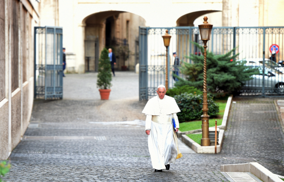 Pope Francis walks alone before day two of the synod