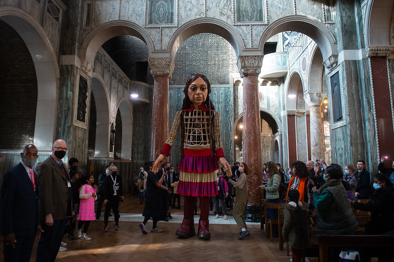 Little Amal migrant puppet welcomed to Westminster Cathedral
