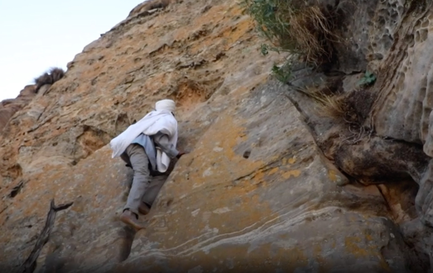 Every day, this priest climbs a sheer cliff to get to church