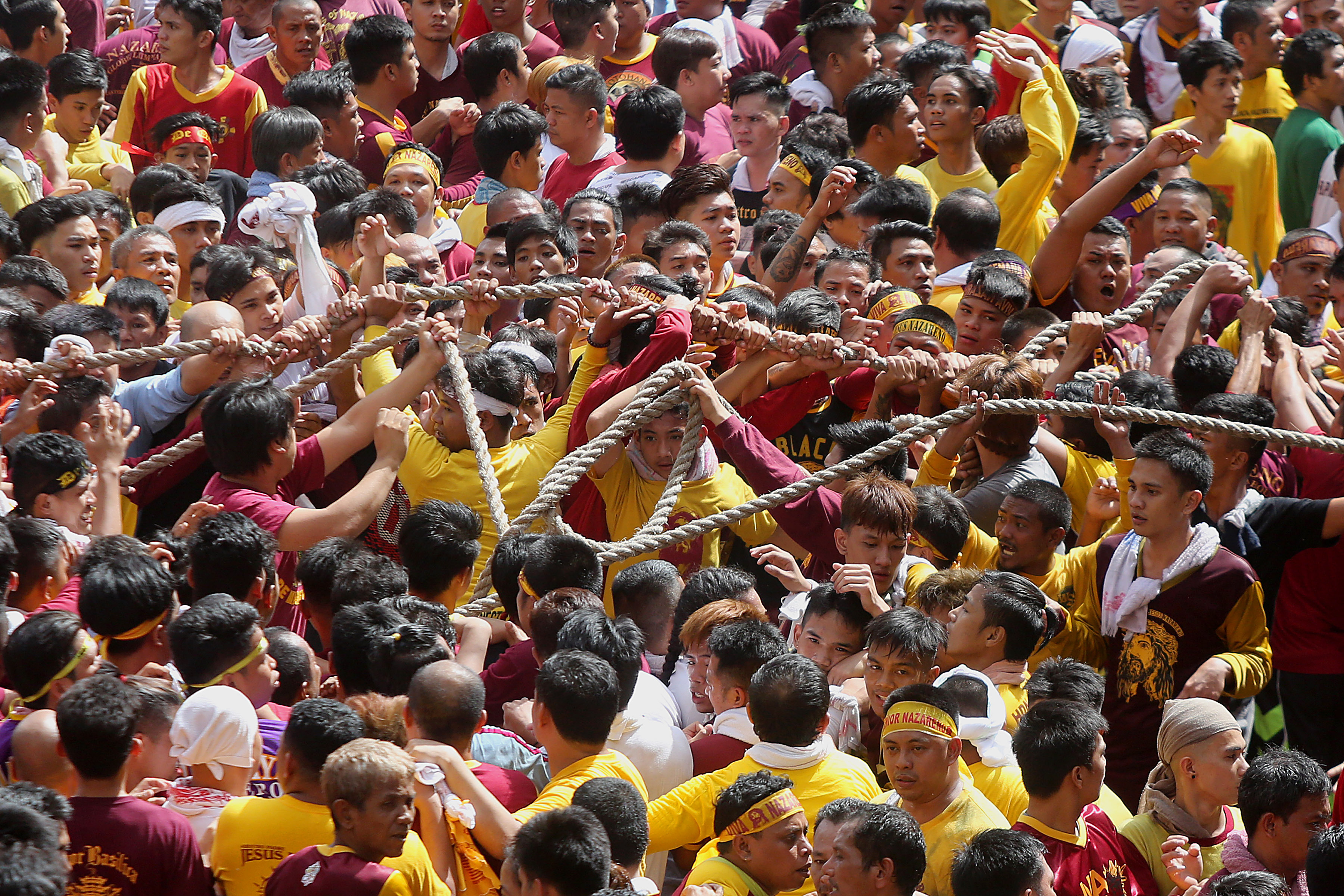 Devotees pull the rope from the life-size statue of the Black Nazarene 