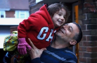 Syrian refugee in Britain, pictured with his daughter