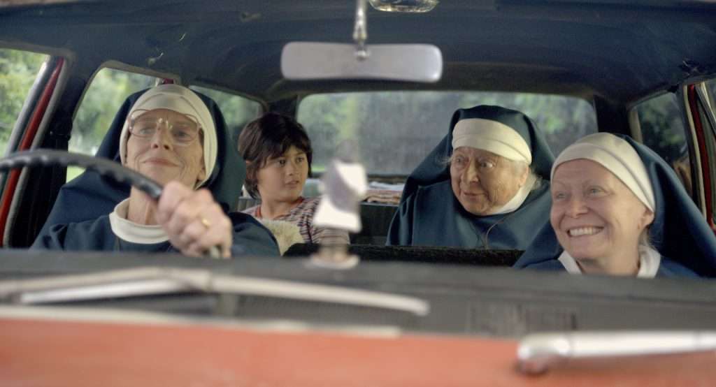 Sisters at the wheel in a moving road movie